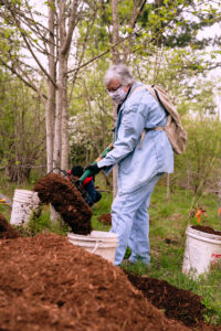 Volunteer scooping mulch